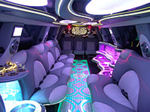 Chauffeur stretch pink Hummer H2 limousine hire interior in UK