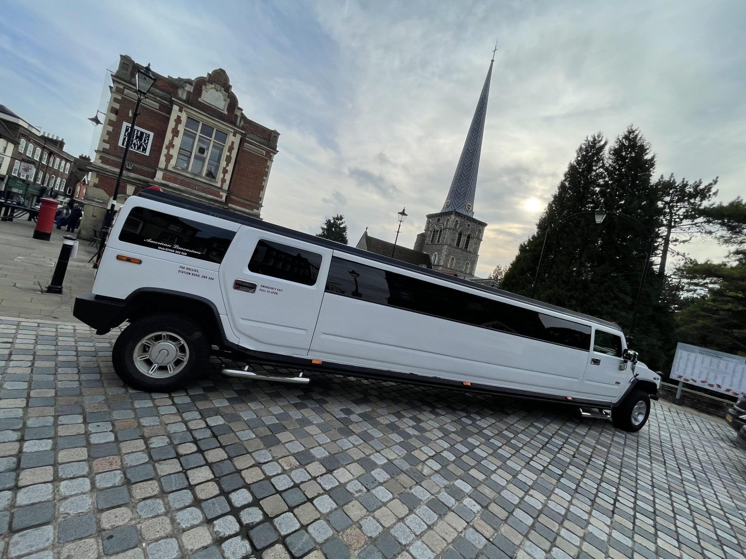 White stretch Hummer limousine for a match day group