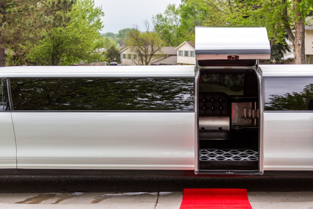White stretch limousine with gull-wing doors for a one-hour arrival